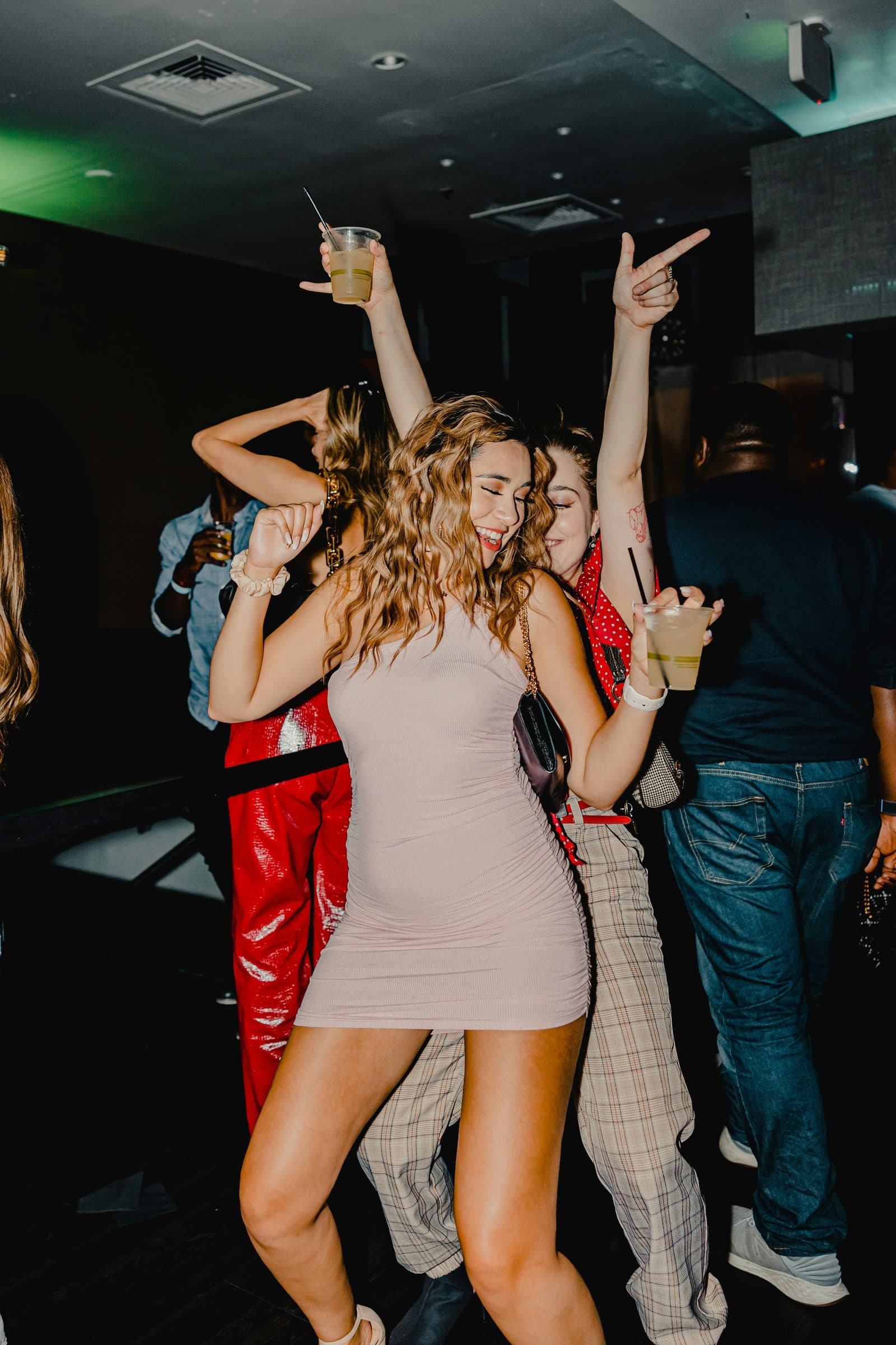 People dancing and celebrating with drinks