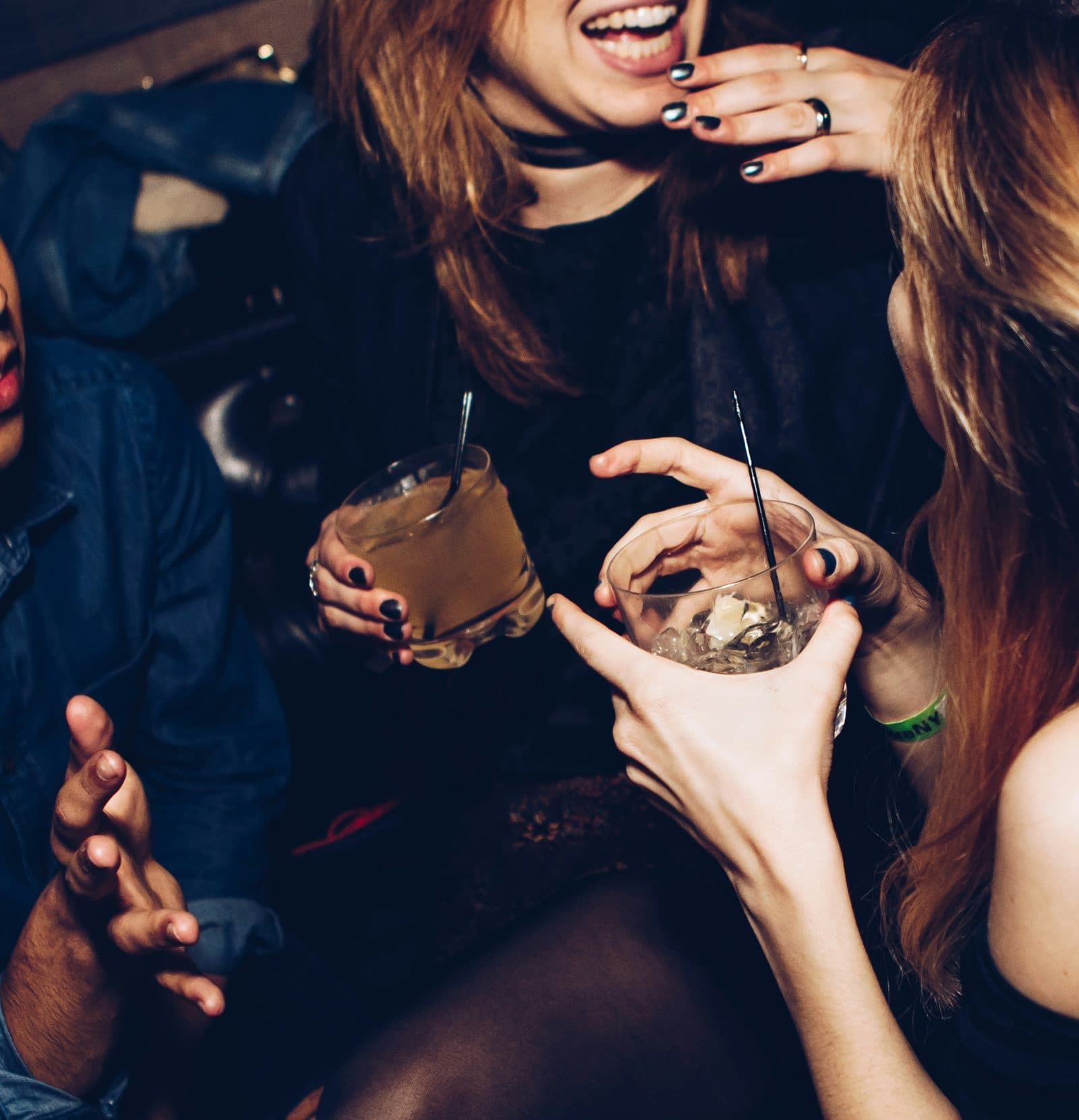 Friends laughing with cocktails